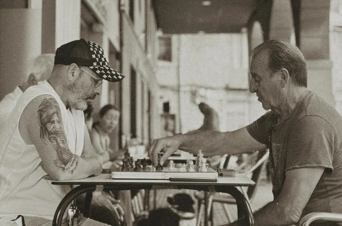 Two players over a street chess board